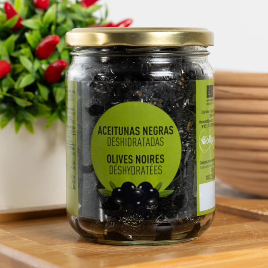 BIO dehydrated black olives in a tall 500 g glass jar, wrinkled matte-black olives with herbs and oil