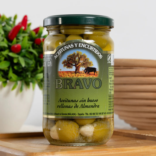 Bravo pitted green olives stuffed with whole almonds in a 170 g glass jar, almond visible in each olive