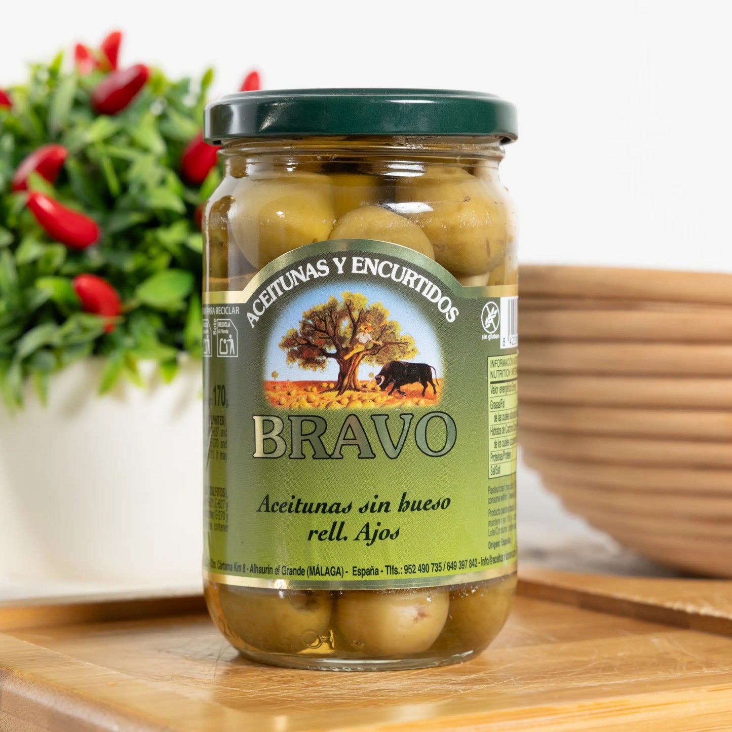 Bravo pitted green olives stuffed with garlic cloves in a 170 g glass jar, garlic visible in each olive