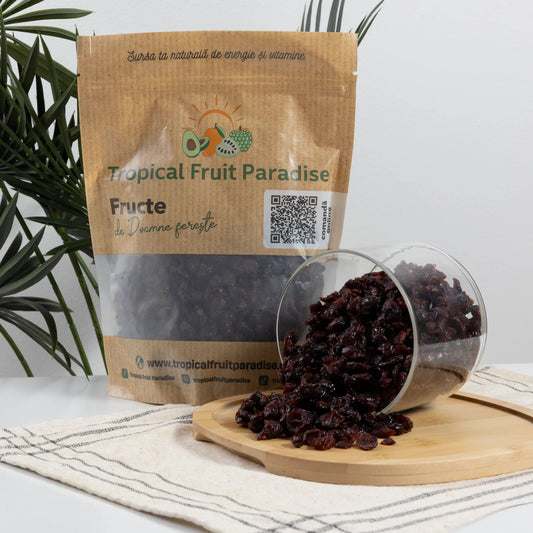 BIO dried cranberries in a Tropical Fruit Paradise kraft pouch, dark red wrinkled berries spilling from a glass jar
