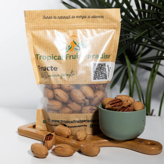 In-shell pecan nuts in a Tropical Fruit Paradise kraft pouch,
several cracked open showing the ridged reddish-brown kernels
