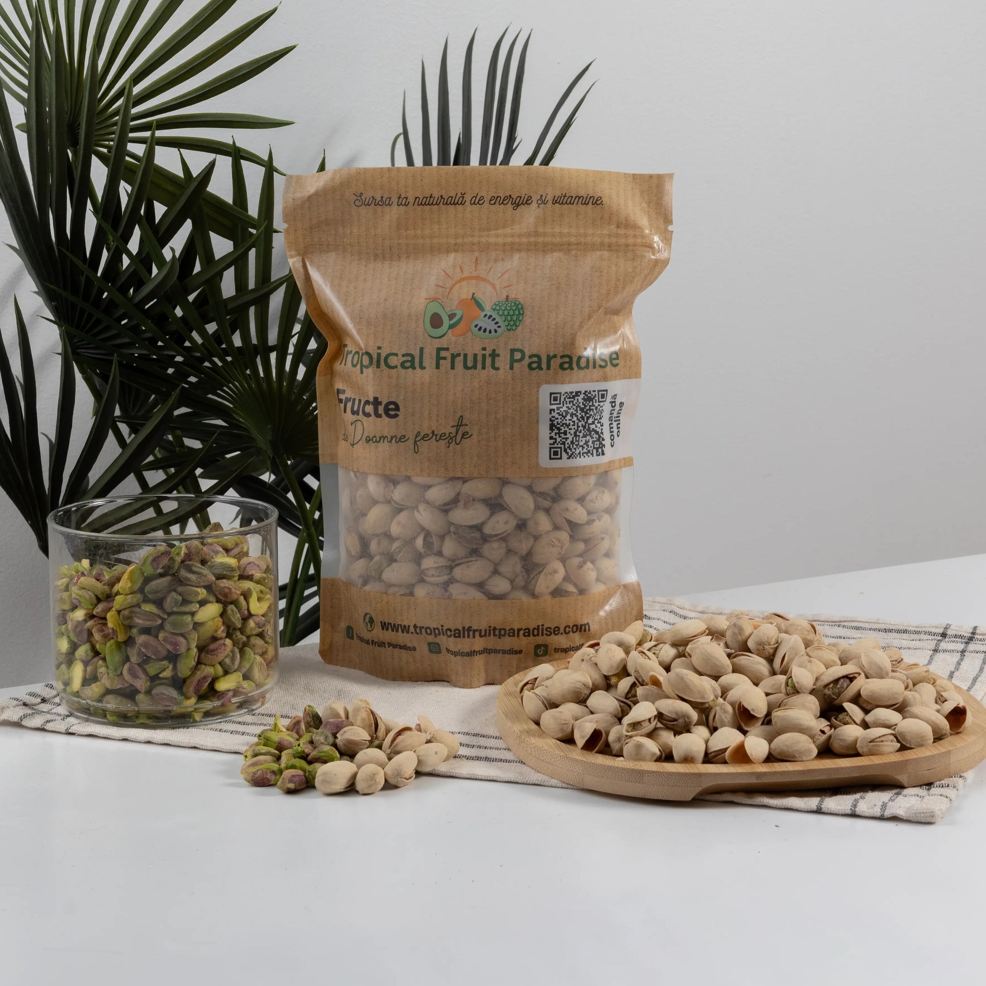 Roasted in-shell pistachios in a 500 g Tropical Fruit Paradise kraft pouch, split beige shells with green kernels inside